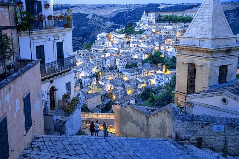 Sicily by car allows you to see ancient cities such as Ragusa at twilight