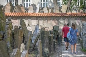 people walking through an old cemetary on a walking tour of Prague
