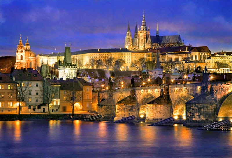 an ancient bridge lit up at night