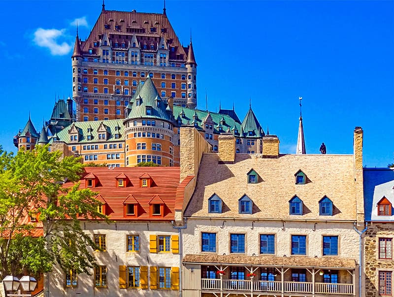 colorful old buildings seen below a lager one seen on a tour of Quebec City