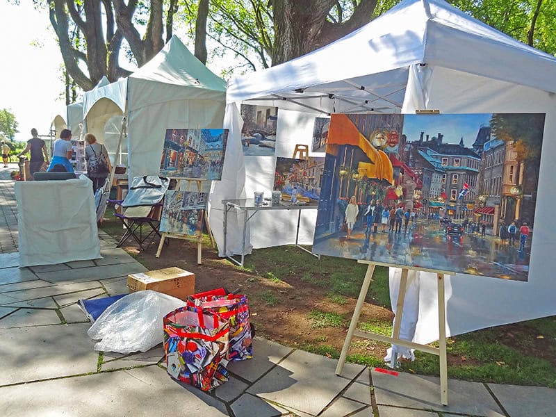 colorful paintings in an outdoor art fair seen on a tour of Quebec City