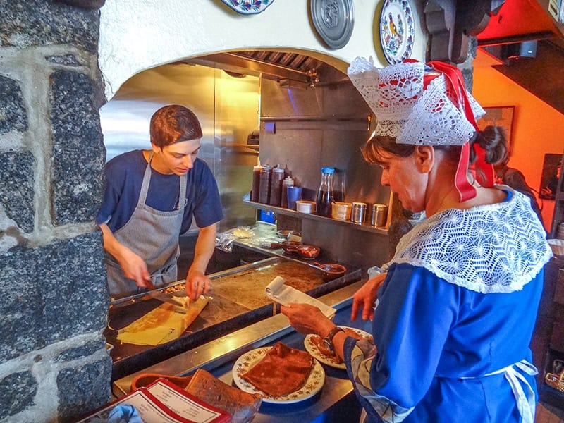 a restaurant waitress and cook in period dress