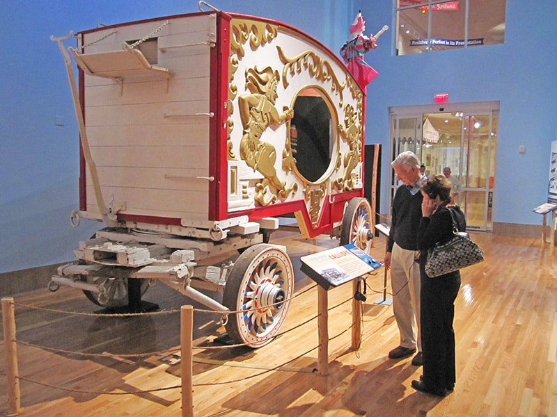 people looking at a cart in a museum - The Ringling Circus Museum - Ringling museum