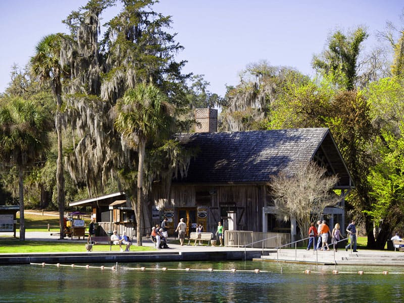 people sitting near a rustic building in Ponce De Leon Springs State Park. one of Florida's freshwater springs