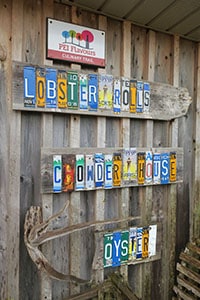 A sign made from old license plates on the wall of a restaurant, well-known for its Prince Edward Island food