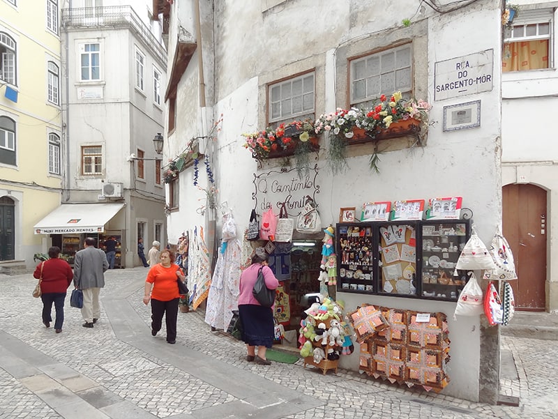 people walking into shops in Coimbra Portugal on a day trip from Lisbon