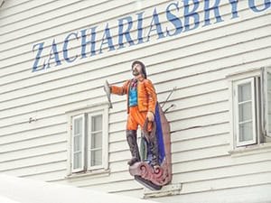 statue of a man holding a fish - things to do in Bergen Norway