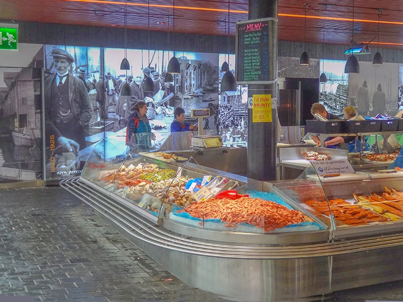 large photos on a wall in a fish market - things to do in Bergen Norway