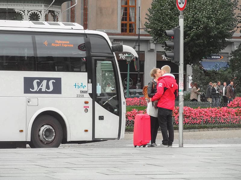 couple kissing at a bus stop - things to do in Bergen Norway