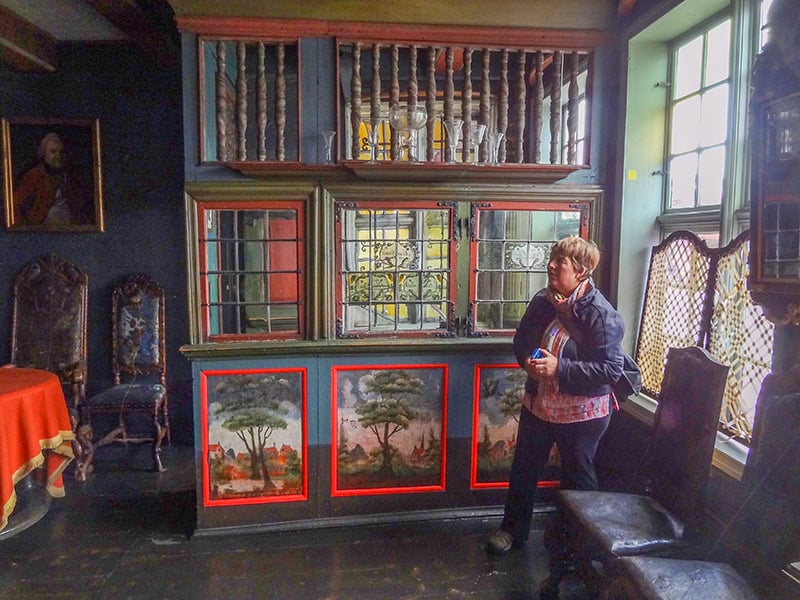 a women in a museum with red-framed paintings - things to do in Bergen Norway
