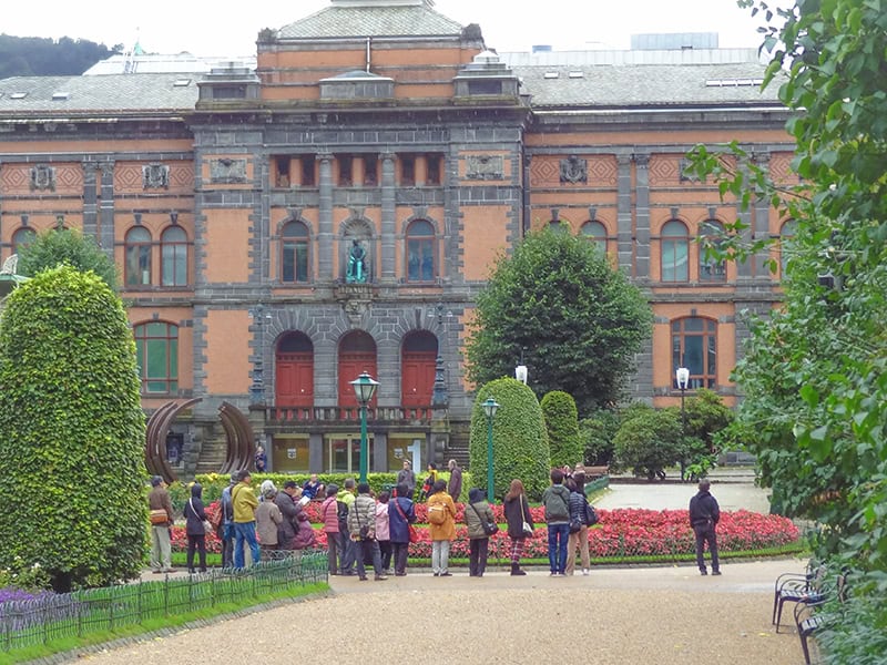 people in front of an old building - things to do in Bergen Norway