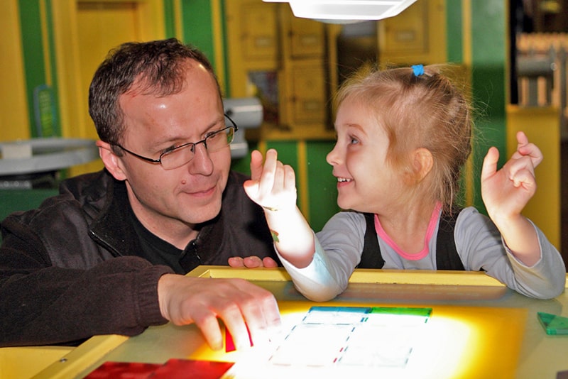 a man playing with a child, one of many Atlanta attractions