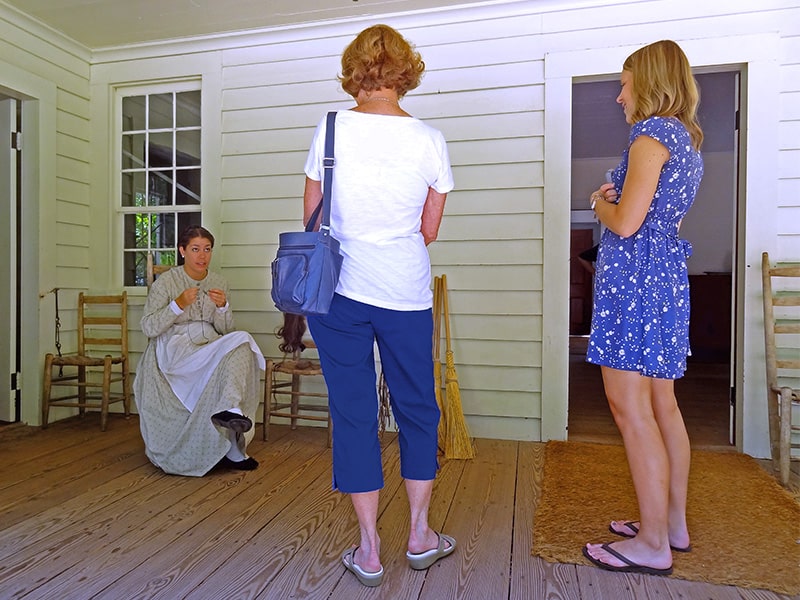 three women talking on a porch