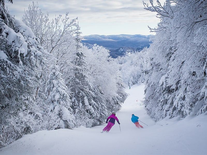 two skiers on the back trails of mont treblandt