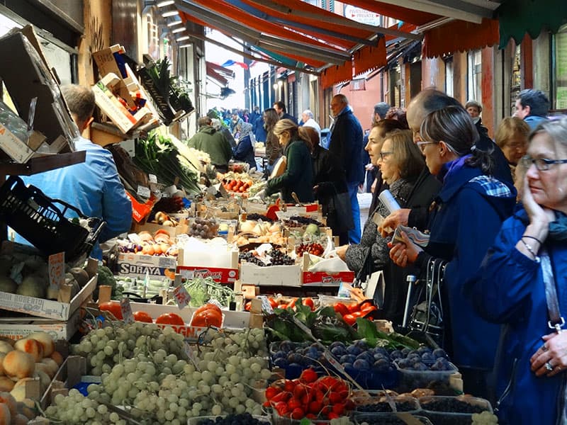 people at vegetable stands in the old market