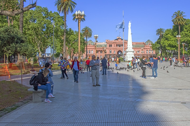 people relaxing in a plaza, one of the things to do in Buenos Aires