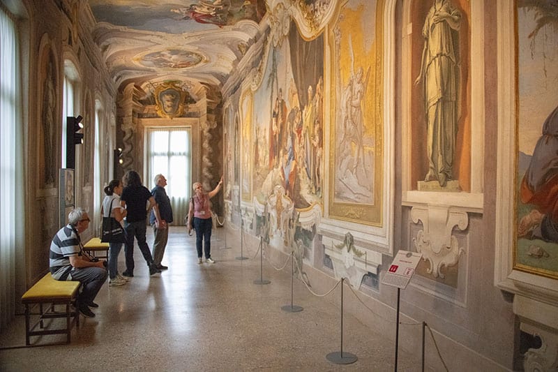people in a museum in Udine, one of the best travel experiences to have in Italy