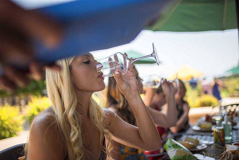 a woman on a wine tour drinking a glass of wine 