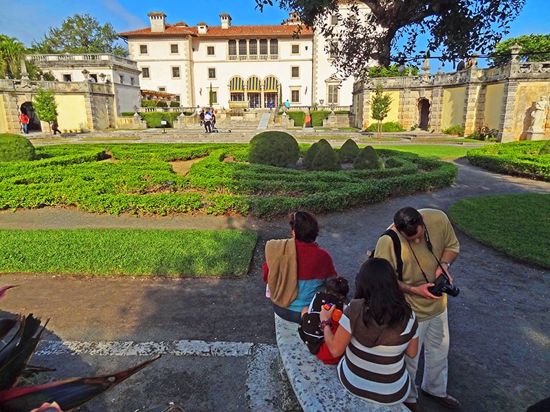 people in a garden at the Vizcaya Museum and Gardens, one of Miami's attractions