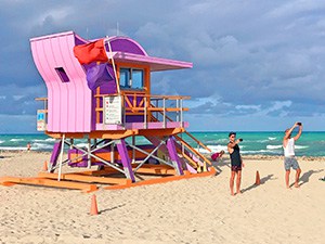 a colorful lifeguard stand on the beach
