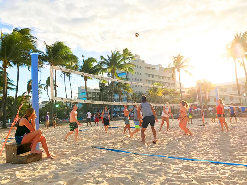 people playing volleyball on the beach in South Beach - where to stay in Miami