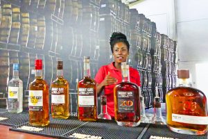A women showing bottles of Barbados rum
