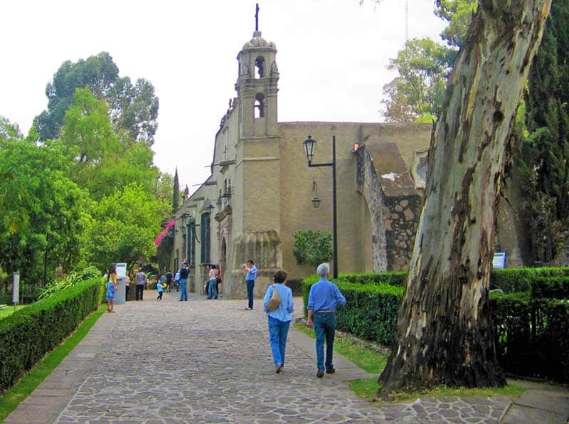 a couple walking towards a museum in a park