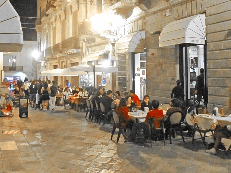 people dining on a pedestrian street in Lecce, one of the hidden gems in Italy