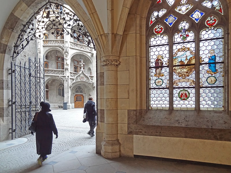 a woman walking through Munich's City Hall, one of the things to do in Munich