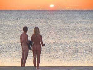 a nude couple watching the sunset at Hedonism II in Negril, Jamaica