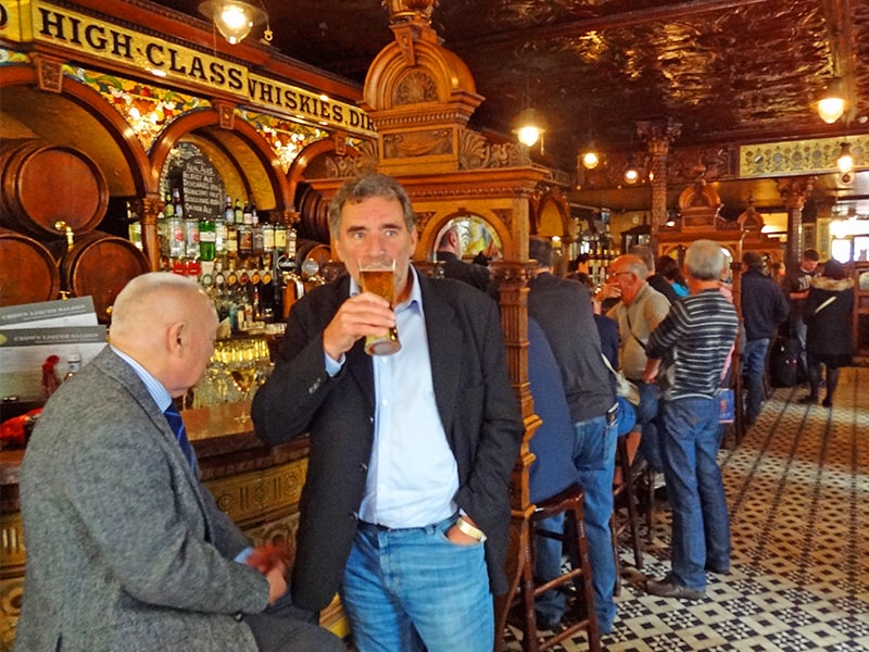 men at a bar in a the Crown Liquor Saloon