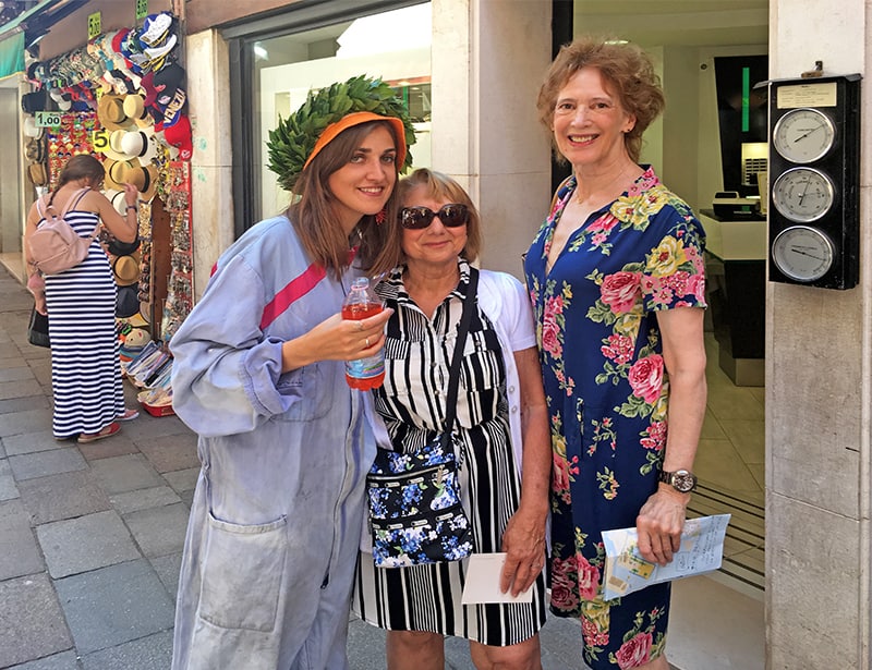 two women traveling meeting a new friend in Italy