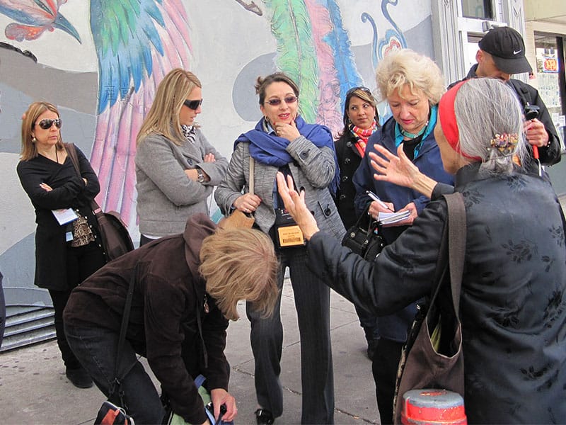 women traveling with a tour guide in Dan Francisco's Chinatown