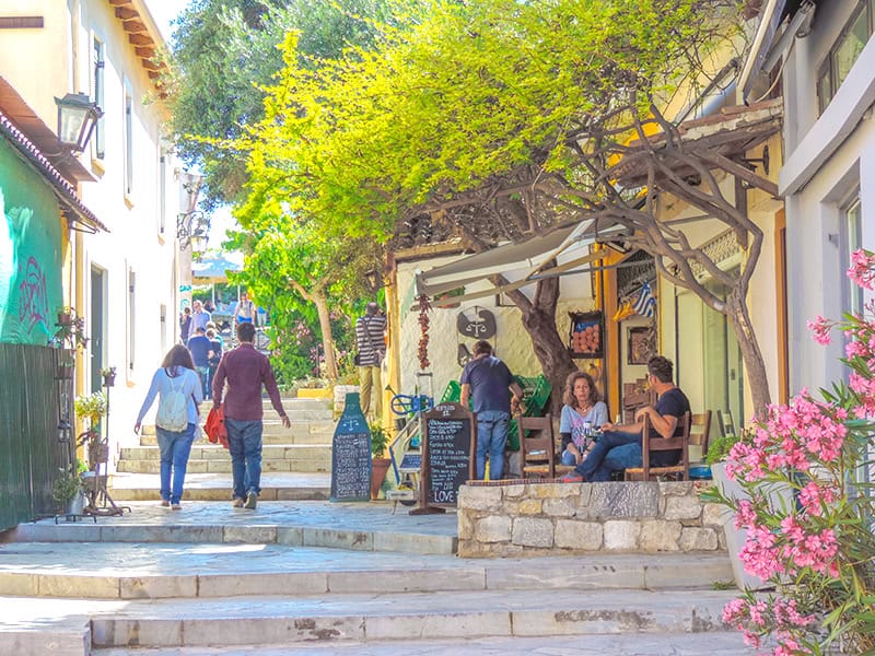 people sitting along a wall in a pretty neighborhood - 2 days in Athens