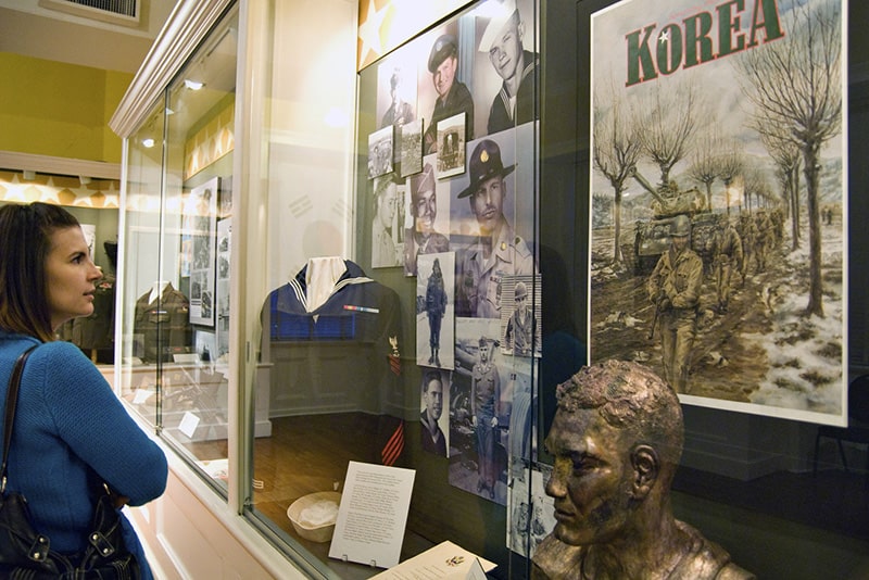 woman looking at an exhibit in a museum