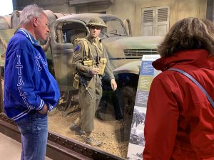 people in a museum looking at a WW2 exhibity