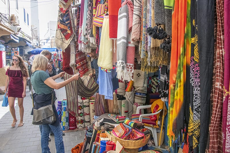 a woman shopping in Essaouira's medina, a good place to visit in Morocco 