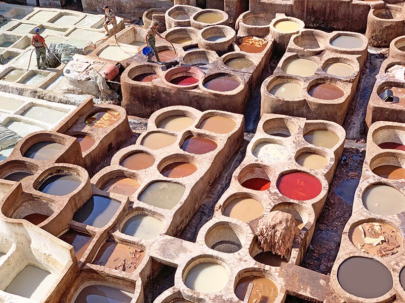 seeing men working in Fez's Chouara Tannery, one of the things to do in Morocco