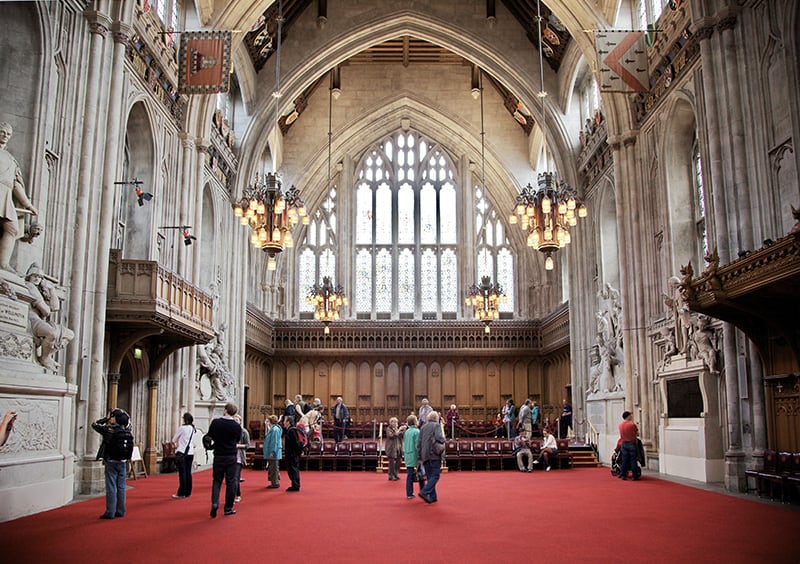 People wandering about The City in a medieval hall