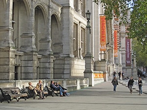 people sitting outside an ornate old building