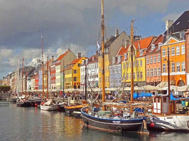 boats docked by clorful buildings