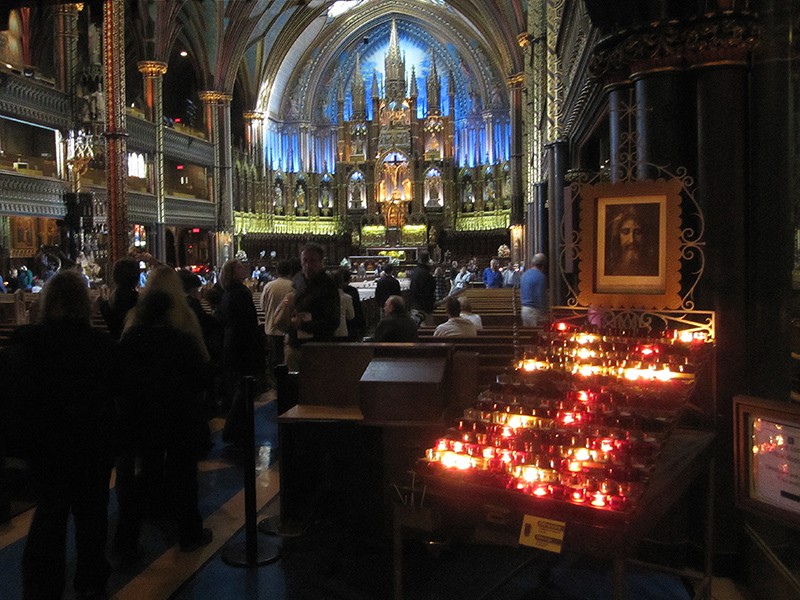 people at mass in a basilica, seen on a weekend in Montreal