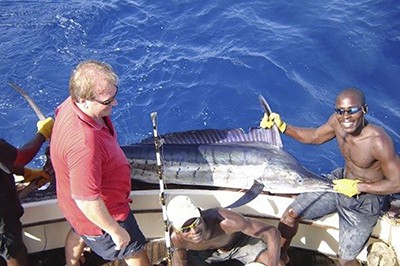 three men deep sea fishing, one of the things to do in Kenya