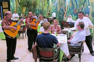 musicians serenating people at a restaurant table