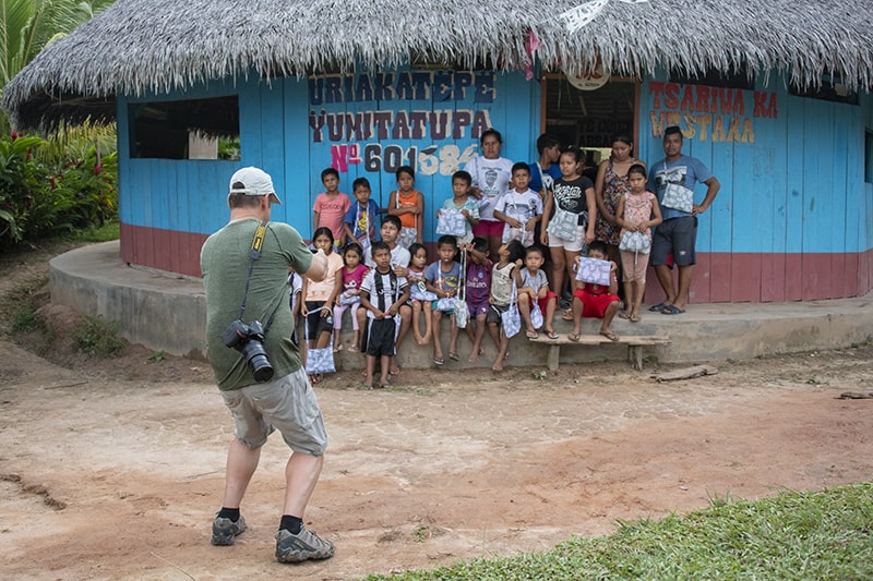 a photograher with children while on our luxury Amazon River cruise