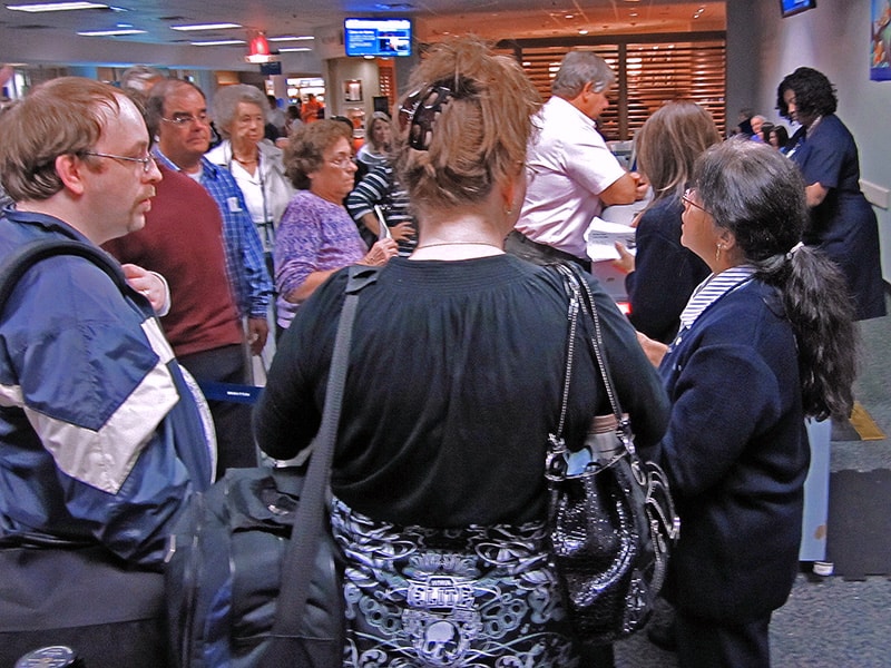 an agent telling passengers about an overbooked flight