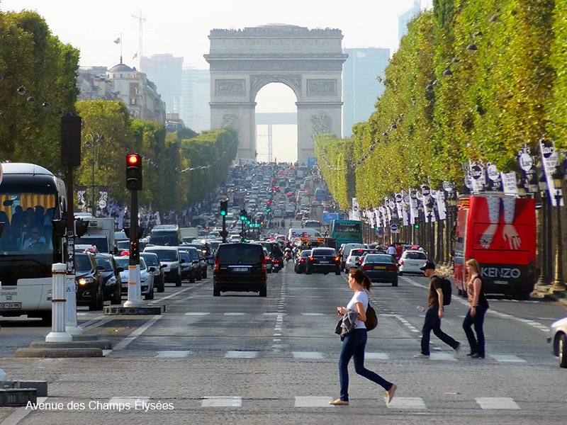 woman cross a street in photos of Paris
