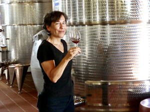 a woman with a glas of wine at wineries in sicily