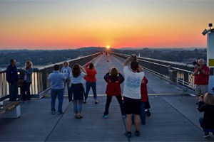 people taking photos of the sunrise