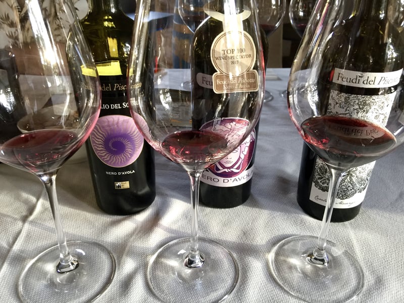 wine bottles on a table at wineries in sicily